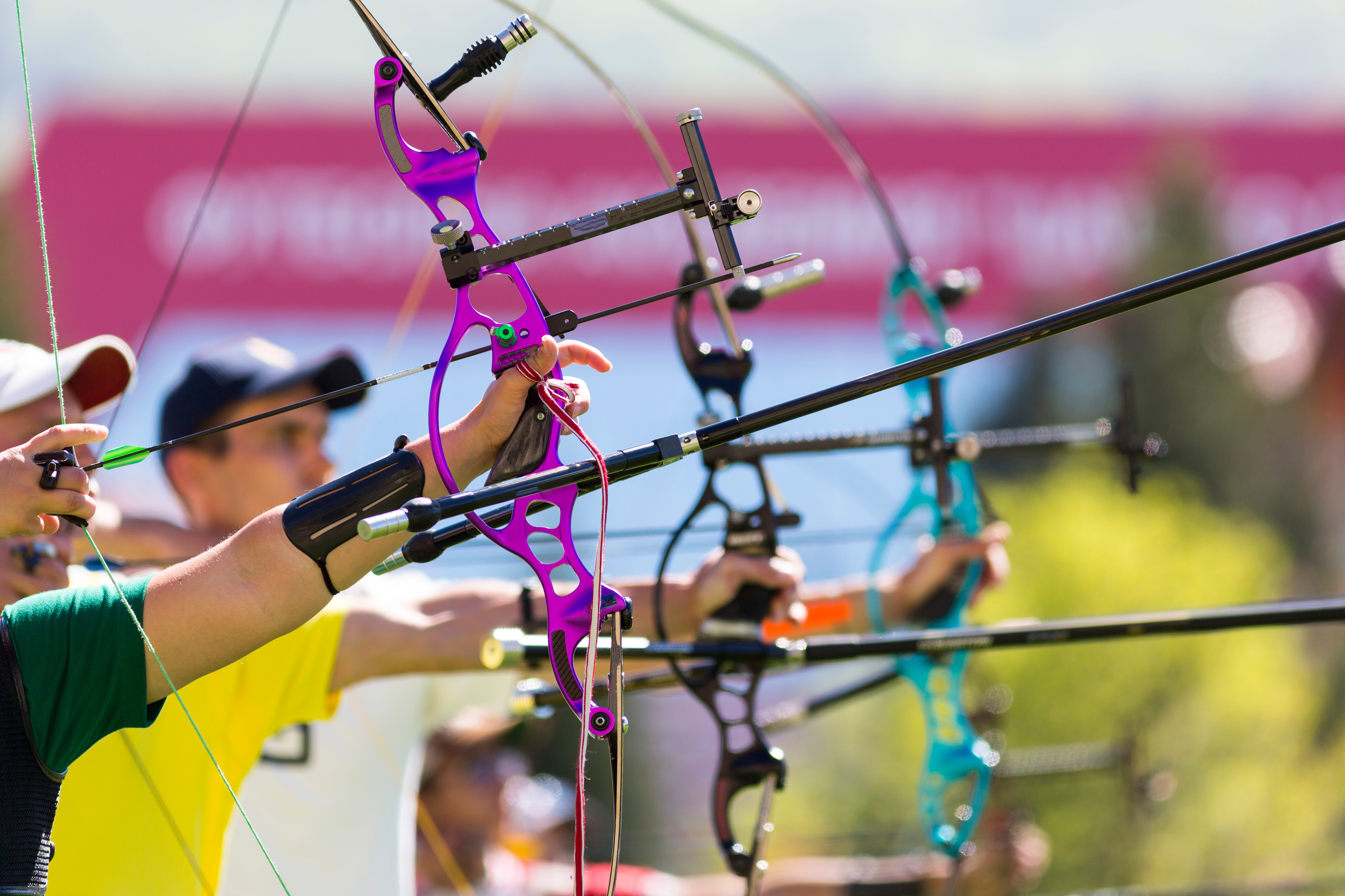 People are shooting with recurve bows during un open archery competition. Bows nad hands only.