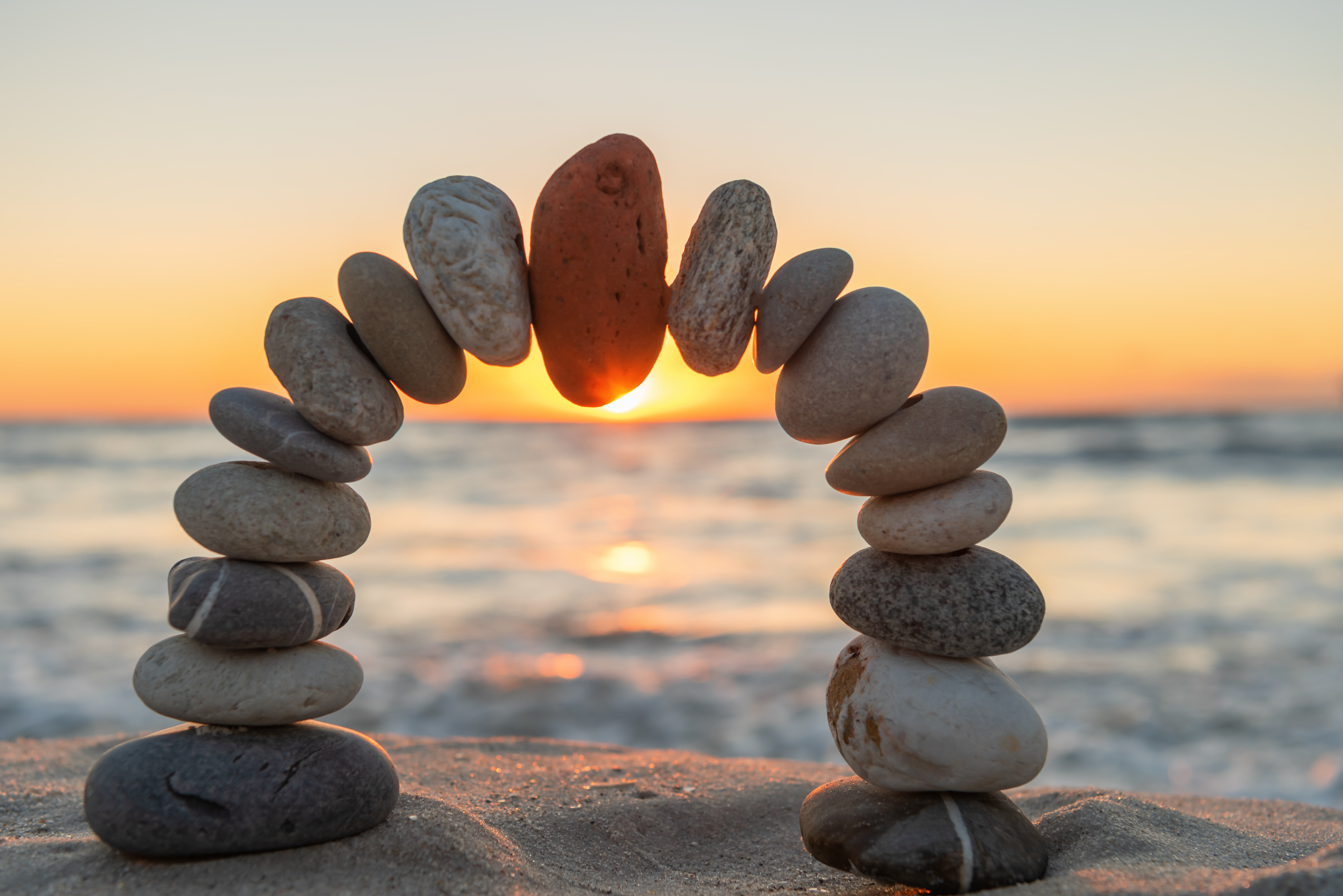 Red on top. Beautiful sunset scene with stone arch,. Wellness and good feeling concept.