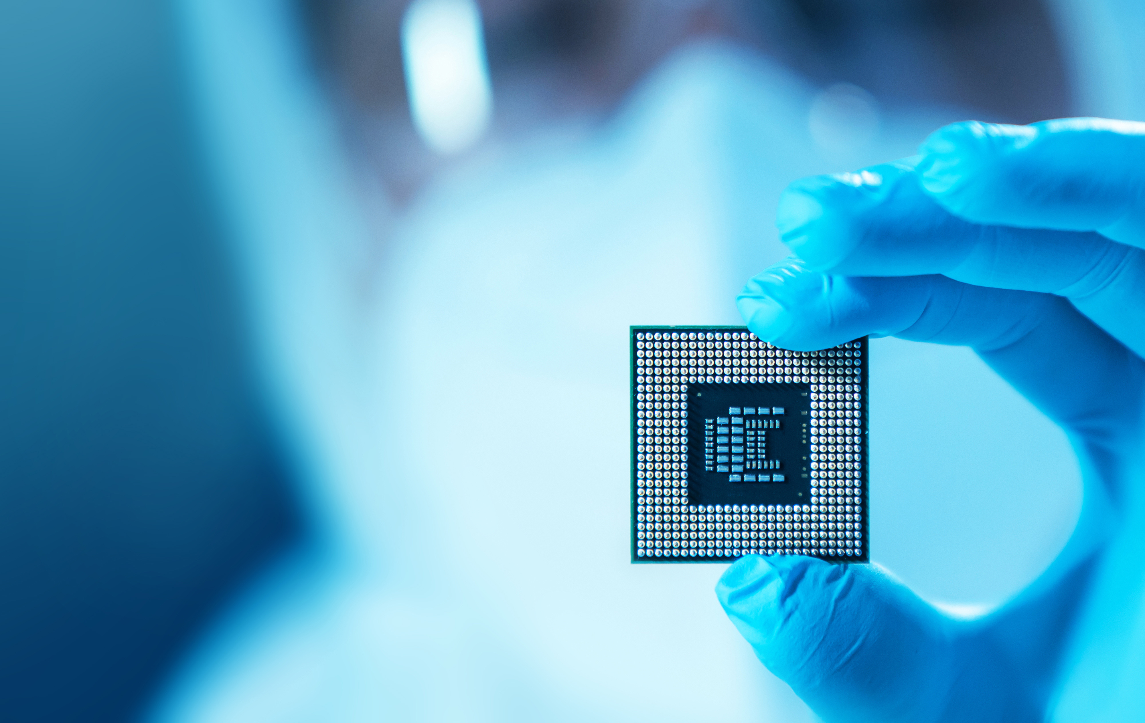 Professional scientist works in a modern scientific laboratory for the research and development of microelectronics and processors. Microprocessor manufacturing worker uses computer technology and equipment.