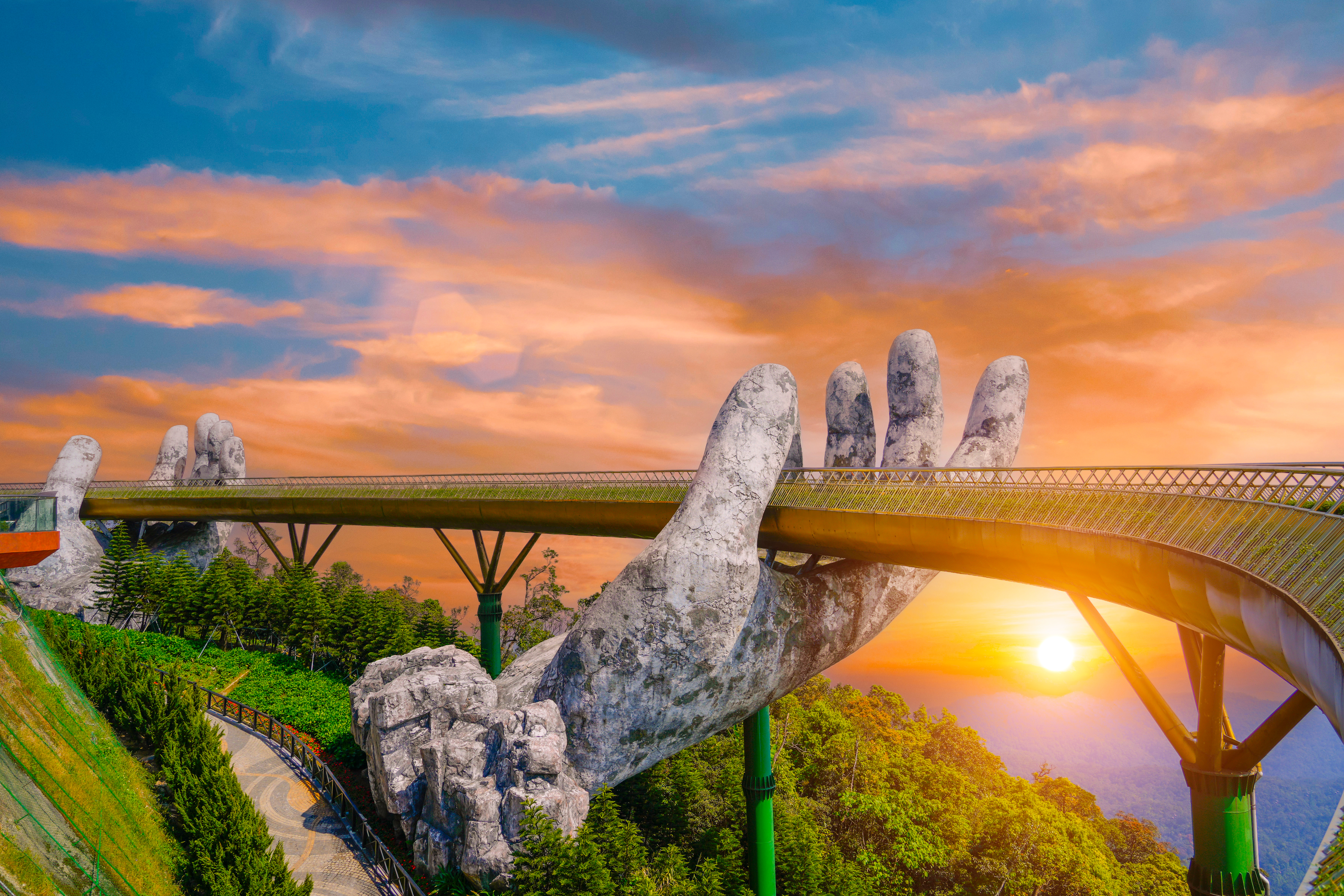 Famous tourist attraction among the tropical jungle in the forests - empty Golden bridge at the top of the Ba Na Hills, Vietnam.